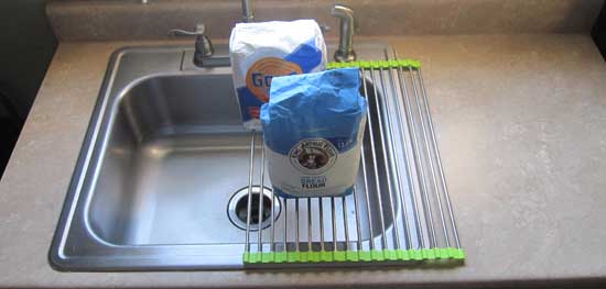 Two bags of flour on over the sink  dish drying rack